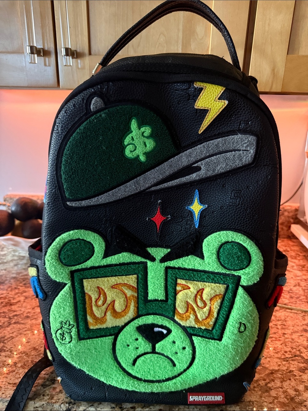 Sprayground Black Backpack with Neon Green Bear Patch and Multicolor Accents
